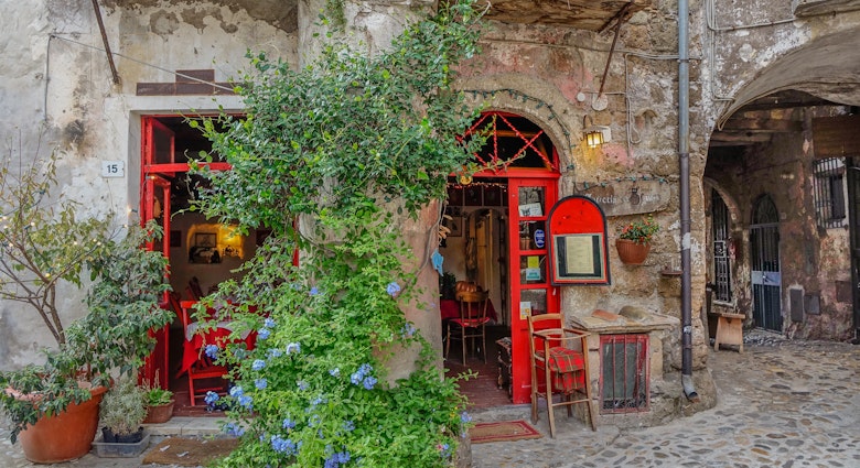 Calcata, Lazio, Italy - September 9, 2017: Small local two-door red with a vine between the two doors, License Type: media, Download Time: 2024-10-10T20:09:37.000Z, User: tasminwaby56, Editorial: true, purchase_order: 65050, job: Online Editorial, client: Rome day trips, other: Tasmin Waby